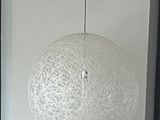 a white light hanging from the ceiling in a room
