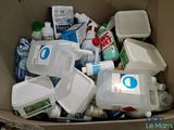 a cardboard box filled with various types of cleaning products