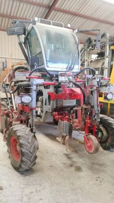 a red tractor that is parked in a garage