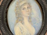 portrait of a woman in a white dress in a black frame