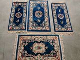 trois tapis et un tapis posé à même le sol dans une pièce