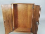 a wooden cabinet with two doors open on a white background
