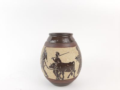a brown vase with a picture of a man on a horse