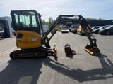 an image of a small excavator parked in a parking lot