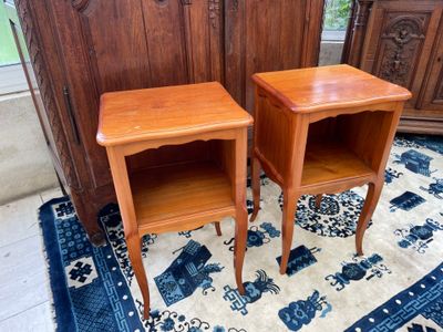 two small wooden tables on a rug in a room