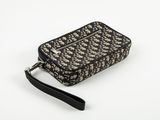 an image of a black and white purse on a white surface