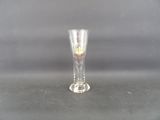a clear glass with a red and yellow design on it