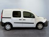 the small white van is parked in a large room