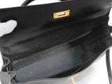 the inside of a black purse being held by a person