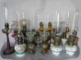 many different types of glass vases and candles on the table