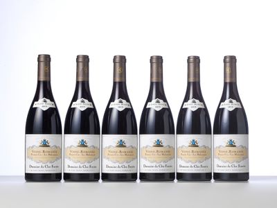 six bottles of wine are lined up on a table
