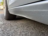 a close up view of a car ' s tire on the road