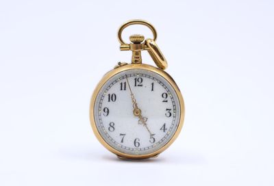 an image of a gold pocket watch on a white background