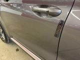 a close up of a car door handle with a sticker on it