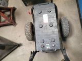 a car that is sitting on the ground with wires attached to it
