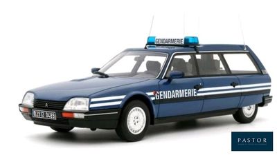 a blue police car that is parked on the side of the road
