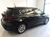 a picture of a black car parked in a showroom