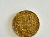 a close up of a gold coin on a white surface