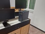 two monitors sitting on top of a dresser in a room