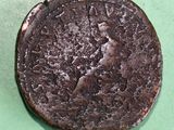 a close up of an old coin on a green surface