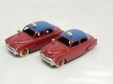 two toy cars that are sitting next to each other