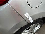 a sticker on the side of a silver car that has a sticker attached to it