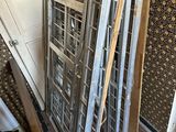 a pile of old windows in the corner of a room