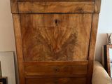 a small wooden cabinet in the corner of a living room