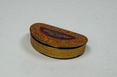 a small wooden box with a red and gold design on it