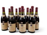 six bouteilles de vin sont alignées sur une surface blanche