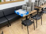 many chairs and tables in a room with a lot of plates on the table