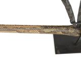 a sculpture of a knife and a stick on a stand