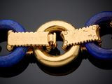 an image of a blue and gold bracelet with a gold clasp