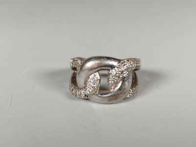 a close up of a silver ring on a white surface