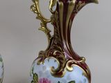 two vases that have been painted with flowers on them