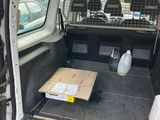 the back of a van with its cargo door open and a box in the trunk