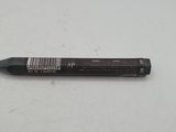 a close up of a black pen on a white surface