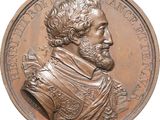 an image of a bronze medal of a man with a beard and mustache
