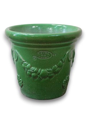 a green planter that is sitting on a white surface