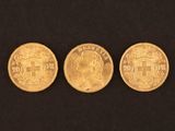 three gold coins, one of which is a sovereign and one of which is a sovereign