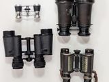 a lot of different types of binoculars that are on the table