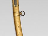 an image of a gold plated dagger with a metal handle