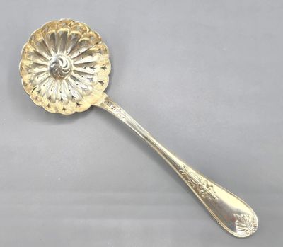 a close up of a spoon with a flower design on it