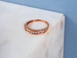 a gold ring sitting on a marble block