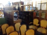 many chairs and tables in a room with a lot of furniture