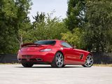 the red sports car is parked in a parking lot near trees