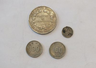 three coins are shown next to each other on a white surface