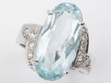 an oval aquamarinee and diamond ring set in 18k white gold