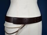 the belt is made of leather and has a metal chain around it