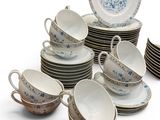 many cups and saucers that are sitting on top of each other